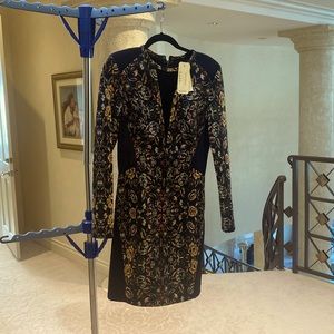 Never worn beautiful dress with sheer neck and sheer sides in black-